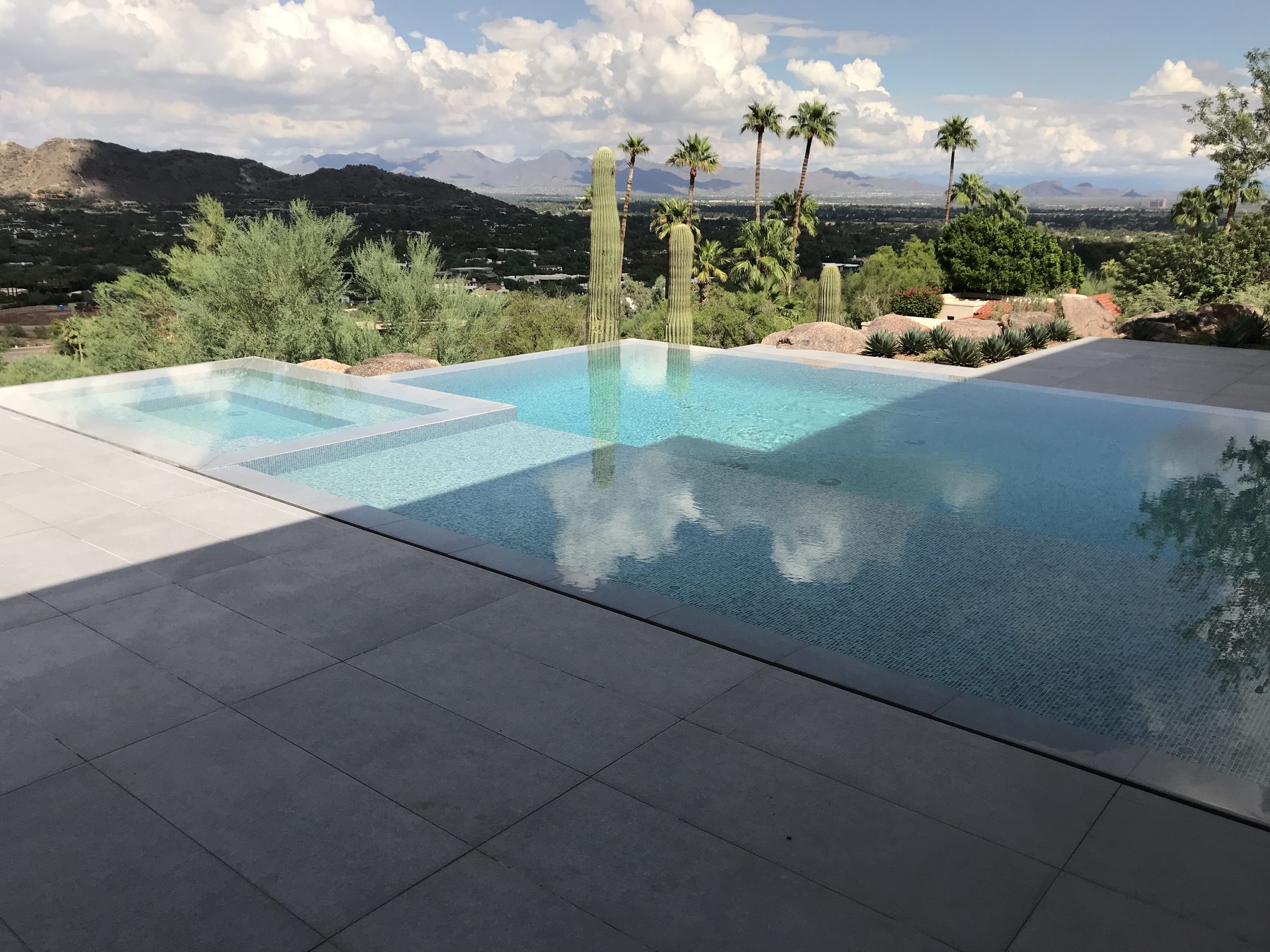 Negative-edge pool with desert mountain views, built by Standard Pools