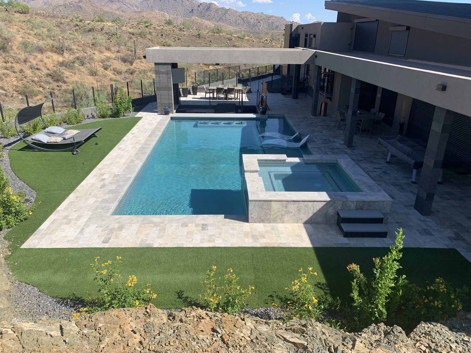 Pool with raised spa addition on a hillside lot — Standard Pools project